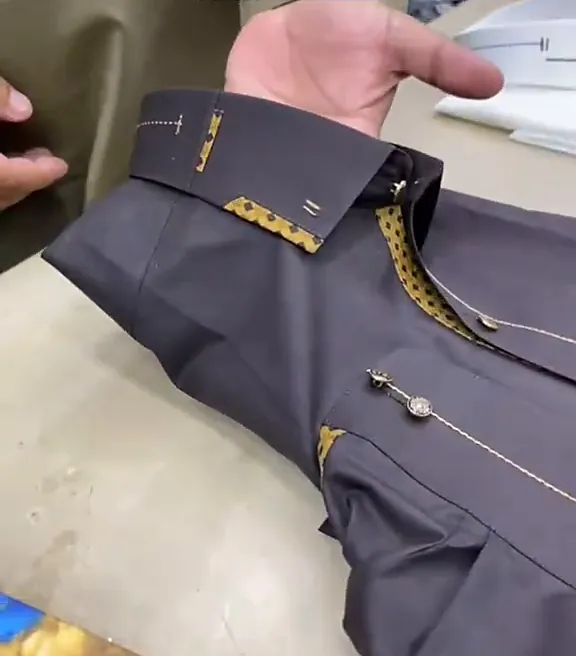 Charcoal kameez laid out with gold piping on the collar and pocket